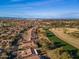 A beautiful aerial view of a well-maintained golf course with lush green fairways and luxury homes in the background at 9638 E Tranquility Way, Sun Lakes, AZ 85248