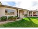 View of the home's well maintained backyard with a covered patio and green grass at 9638 E Tranquility Way, Sun Lakes, AZ 85248