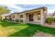 Backyard showcasing a covered patio, lush green grass, and exterior of the home at 9638 E Tranquility Way, Sun Lakes, AZ 85248