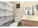 Bathroom with a toilet, sink, and striped shower curtain, offering functionality and privacy at 9638 E Tranquility Way, Sun Lakes, AZ 85248