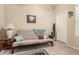 Bedroom with a comfortable futon, decorative pillows, and a vintage-style accent rug at 9638 E Tranquility Way, Sun Lakes, AZ 85248