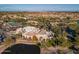 Expansive aerial perspective showcasing the community's clubhouse with a view of the meticulously maintained golf course at 9638 E Tranquility Way, Sun Lakes, AZ 85248