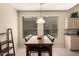 Bright dining area with a wood table, modern chairs, and a decorative light fixture at 9638 E Tranquility Way, Sun Lakes, AZ 85248