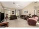 Comfortable living room with neutral carpet, ceiling fan, and sliding glass door at 9638 E Tranquility Way, Sun Lakes, AZ 85248