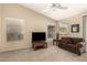 Cozy living room featuring a media center and lots of natural light at 9638 E Tranquility Way, Sun Lakes, AZ 85248