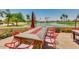 Outdoor seating area with a modern fire table and a scenic water view at 9638 E Tranquility Way, Sun Lakes, AZ 85248