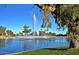 Lush pond with a fountain, palm trees, and blue skies at 9638 E Tranquility Way, Sun Lakes, AZ 85248