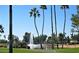 Scenic pond with a fountain and palm trees set against a blue sky at 9638 E Tranquility Way, Sun Lakes, AZ 85248