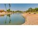 Picturesque pond with a fountain, landscaping, and view of waterfront homes at 9638 E Tranquility Way, Sun Lakes, AZ 85248