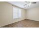 Bedroom with a ceiling fan and window at 1170 S Agnes Ln, Gilbert, AZ 85296
