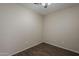 This bedroom features a ceiling fan and wood-look floors at 1170 S Agnes Ln, Gilbert, AZ 85296