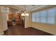 Inviting dining area featuring wood floors, a modern chandelier, stainless steel appliances and ample natural light at 1170 S Agnes Ln, Gilbert, AZ 85296