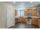 A well-equipped kitchen with stainless steel appliances, wood cabinets, and dark wood flooring at 1170 S Agnes Ln, Gilbert, AZ 85296