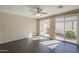 A bright and airy living room featuring dark wood flooring, a ceiling fan, and access to the outdoor patio at 1170 S Agnes Ln, Gilbert, AZ 85296