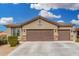 Attractive single-story home with a three-car garage and well-maintained desert landscaping at 12180 W Rio Vista Ln, Avondale, AZ 85323