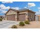 Attractive single-story home with a three-car garage, stone accents, and low-maintenance landscaping at 12180 W Rio Vista Ln, Avondale, AZ 85323