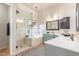 Bright bathroom featuring a soaking tub, glass-enclosed shower, and double sinks at 12837 S 41St St, Phoenix, AZ 85044