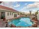 Refreshing backyard pool with rock features, perfect for cooling off on hot days at 12837 S 41St St, Phoenix, AZ 85044