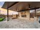 Covered patio features built in bbq, putting green, stacked stone, and a desert sunset at 13018 S 177Th Ln, Goodyear, AZ 85338