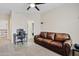 Bedroom with a brown leather couch, computer desk, and ceiling fan at 1307 E Desert Broom Way, Phoenix, AZ 85048