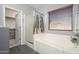 Bathroom with a large shower, bathtub, and window view at 16038 W Acapulco Ln, Surprise, AZ 85379