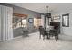 Elegant dining area featuring a modern chandelier and large windows offering plenty of natural light at 16038 W Acapulco Ln, Surprise, AZ 85379