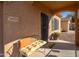 Inviting front porch with a cozy bench, decorative pillows, and a welcoming doormat at 16038 W Acapulco Ln, Surprise, AZ 85379