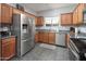 Well-lit kitchen featuring stainless steel appliances and gray countertops at 16038 W Acapulco Ln, Surprise, AZ 85379