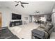 Spacious living room featuring plush seating, a fireplace, and ample natural light at 16038 W Acapulco Ln, Surprise, AZ 85379