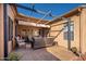 Covered patio with brick flooring offering a relaxing outdoor space at 16038 W Acapulco Ln, Surprise, AZ 85379
