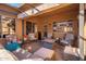 Covered patio with comfortable seating arrangement and brick flooring at 16038 W Acapulco Ln, Surprise, AZ 85379