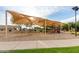Community playground with shade structure, swings, and slides, ideal for Gathering fun at 16038 W Acapulco Ln, Surprise, AZ 85379
