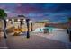 Relaxing pool area with gazebo, patio furniture, and charming decor for outdoor enjoyment at 16038 W Acapulco Ln, Surprise, AZ 85379