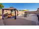 Relaxing pool area with gazebo, patio furniture, and charming decor for outdoor enjoyment at 16038 W Acapulco Ln, Surprise, AZ 85379