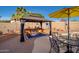 Inviting pool area with gazebo, ample seating, and stylish decor for outdoor living at 16038 W Acapulco Ln, Surprise, AZ 85379