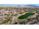 Expansive aerial view of the Estrella community featuring a lush golf course, beautiful homes, and desert landscape with mountain views at 18143 W Buckhorn Dr, Goodyear, AZ 85338