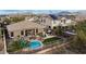 Aerial view showcasing a private backyard oasis, featuring a pool, hot tub, and desert landscaping at 18143 W Buckhorn Dr, Goodyear, AZ 85338