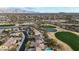 Aerial view of the Estrella community, showcasing houses, desert landscape, golf course, pond, and mountain views at 18143 W Buckhorn Dr, Goodyear, AZ 85338