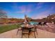 A beautifully landscaped backyard features a firepit, pool, and mountain views, perfect for outdoor entertaining at 18143 W Buckhorn Dr, Goodyear, AZ 85338