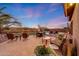 Backyard patio features multiple seating areas, a firepit, desert landscaping, and a refreshing pool, perfect for entertaining at 18143 W Buckhorn Dr, Goodyear, AZ 85338