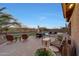 A serene backyard oasis featuring lush greenery, an outdoor dining set, and cozy seating areas by the pool at 18143 W Buckhorn Dr, Goodyear, AZ 85338