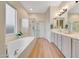 Serene bathroom featuring double vanity, soaking tub and glass enclosed shower at 18143 W Buckhorn Dr, Goodyear, AZ 85338
