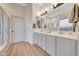 Bright bathroom boasts dual sinks, spacious counters, and a glass-enclosed shower at 18143 W Buckhorn Dr, Goodyear, AZ 85338