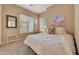 Comfortable bedroom with a bed, two windows, and carpeted floors at 18143 W Buckhorn Dr, Goodyear, AZ 85338