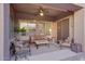 Relaxing covered patio featuring a ceiling fan and cozy furniture, perfect for outdoor living and entertaining at 18143 W Buckhorn Dr, Goodyear, AZ 85338
