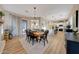 Open dining area with a wooden table, chandelier and sliding doors to the backyard at 18143 W Buckhorn Dr, Goodyear, AZ 85338