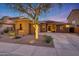 Charming single-story home with desert landscaping, stylish exterior finishes, and a well-manicured front yard at 18143 W Buckhorn Dr, Goodyear, AZ 85338