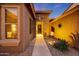 Inviting front entrance with stone accents, manicured landscaping, and a charming walkway leading to the front door at 18143 W Buckhorn Dr, Goodyear, AZ 85338