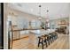 Open-concept kitchen featuring a large island with seating, modern appliances, and a view into the dining area at 18143 W Buckhorn Dr, Goodyear, AZ 85338