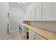 Well-organized laundry room with ample counter space and modern appliances at 18143 W Buckhorn Dr, Goodyear, AZ 85338